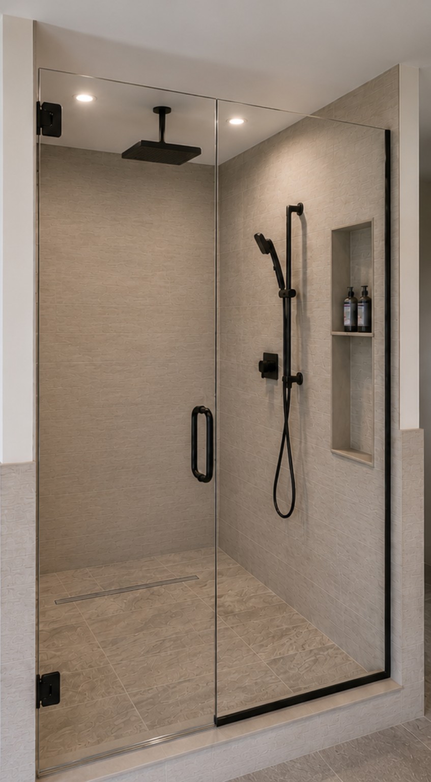 Walk-in shower with textured tile and matte black fixtures